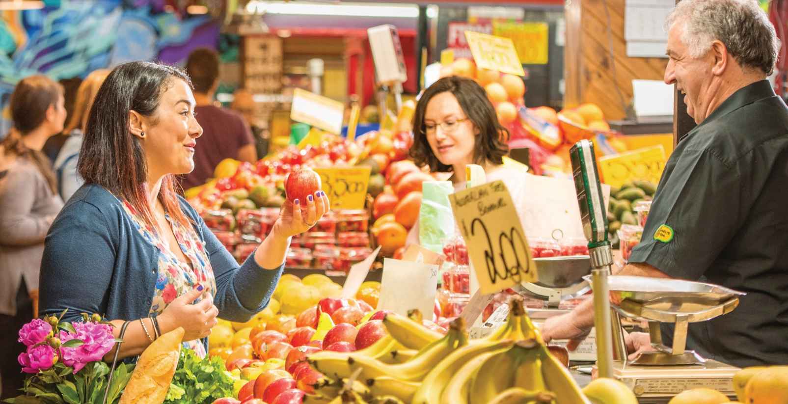 woman buying from a fruit market
