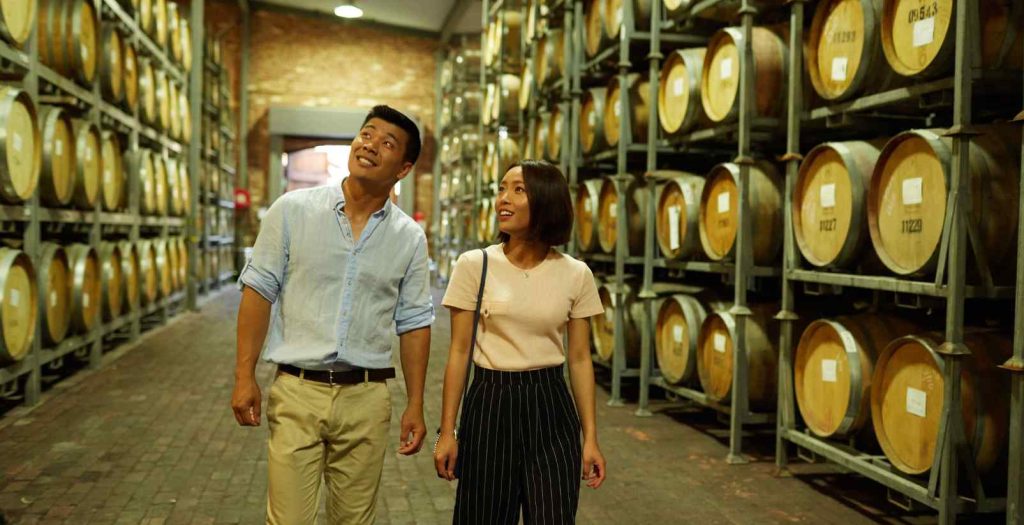 couple walking through winery storage