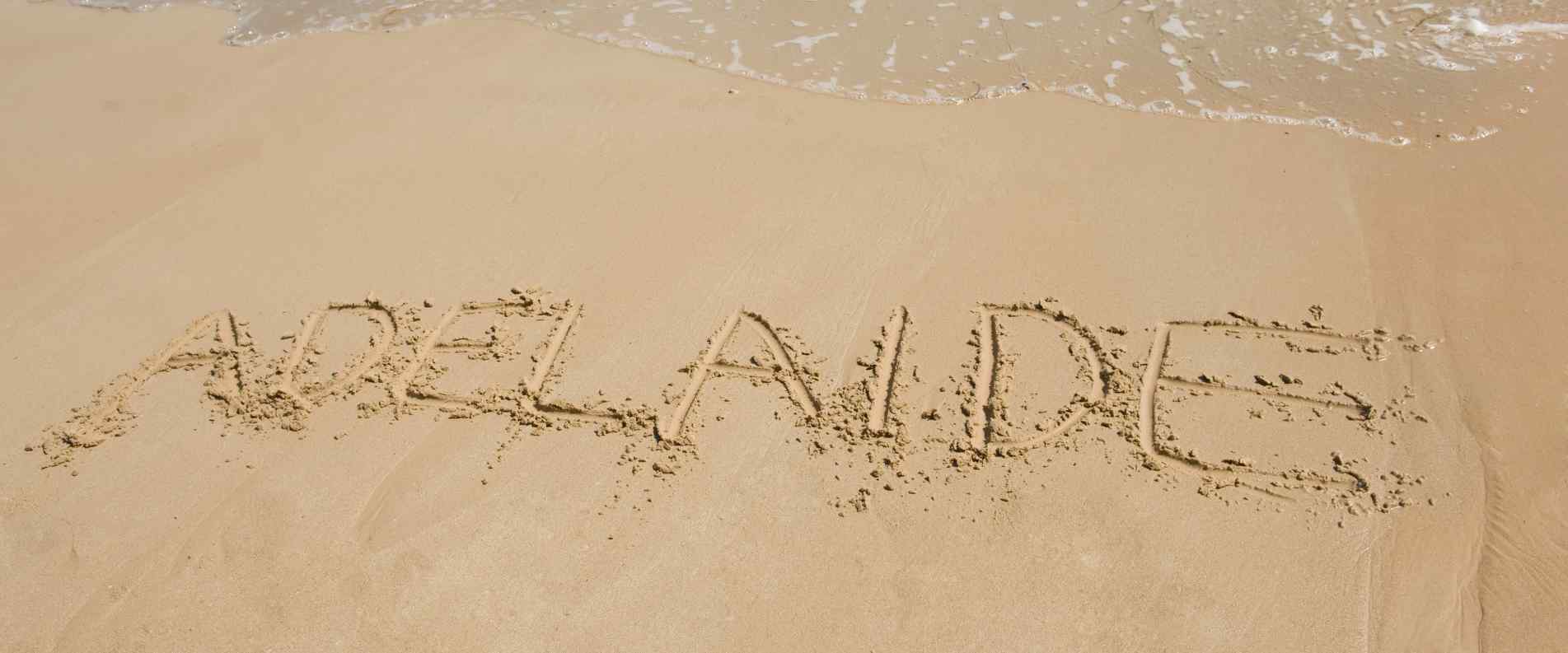 the word 'Adelaide' written in sand on beach