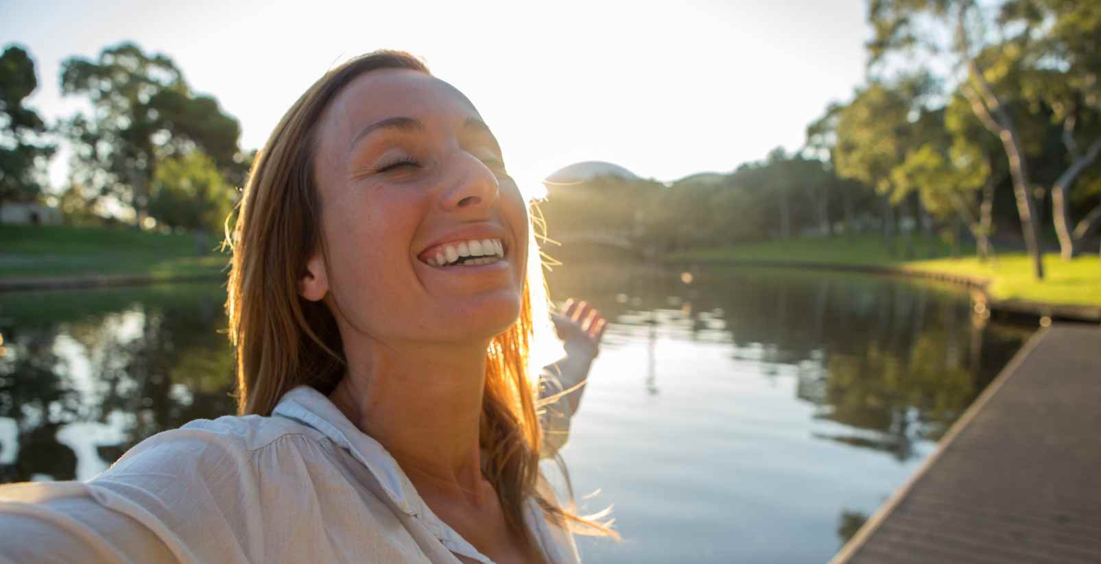 woman holding out arm in park